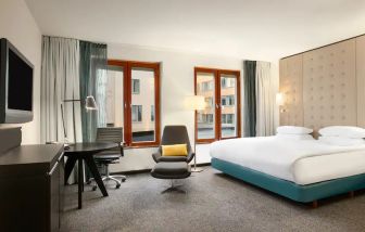 King bedroom with desk at the Hilton Stockholm Slussen.