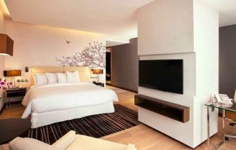 Spacious king bedroom with desk and TV screen at the Hilton Colombo Residence.