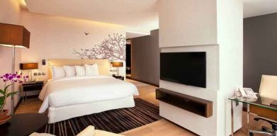 Spacious king bedroom with desk and TV screen at the Hilton Colombo Residence.