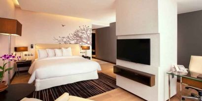 Spacious king bedroom with desk and TV screen at the Hilton Colombo Residence.