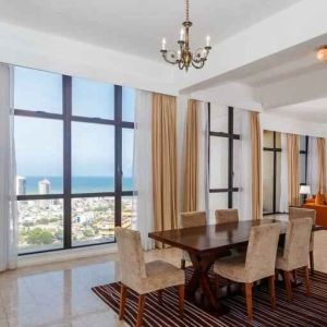 Living room with sofas, tables and chairs at the Hilton Colombo Residence.