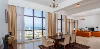 Living room with sofas, tables and chairs at the Hilton Colombo Residence.