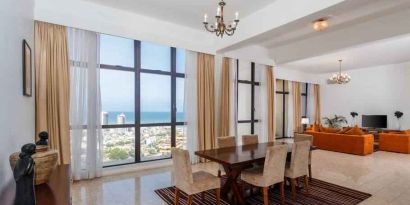 Living room with sofas, tables and chairs at the Hilton Colombo Residence.