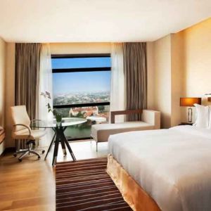 King guestroom with working station along the window at the Hilton Colombo Residence.