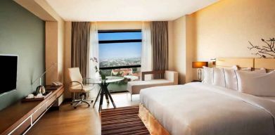 King guestroom with working station along the window at the Hilton Colombo Residence.