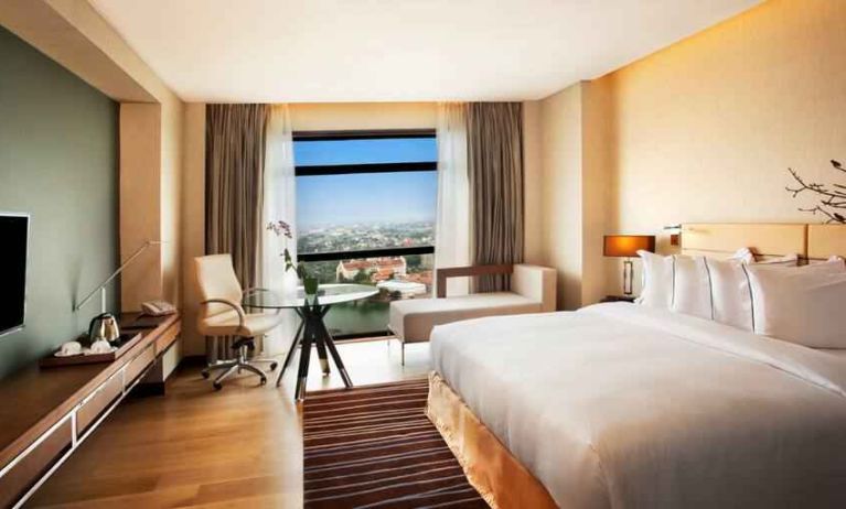 King guestroom with working station along the window at the Hilton Colombo Residence.