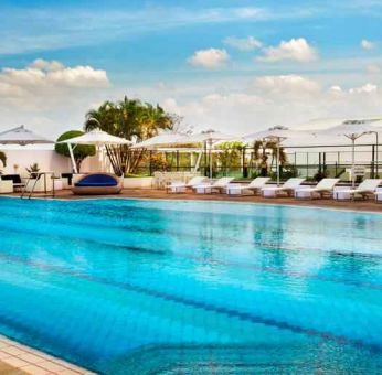 Relaxing outdoor pool area with lounges at the Hilton Colombo Residence.