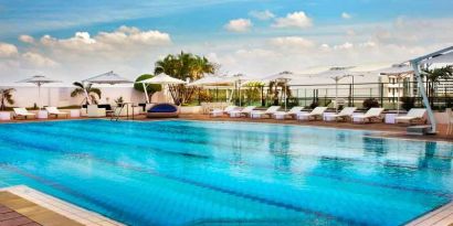 Relaxing outdoor pool area with lounges at the Hilton Colombo Residence.