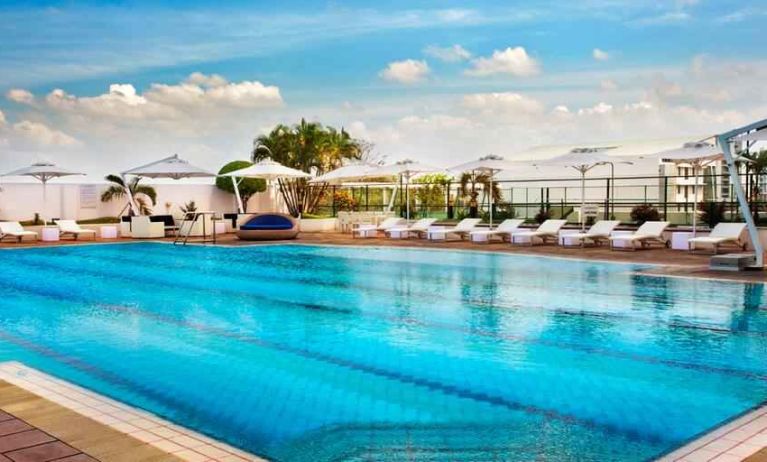 Relaxing outdoor pool area with lounges at the Hilton Colombo Residence.