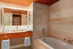 clean and spacious bathroom with bath at Hilton Kuwait Resort.