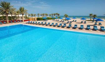 stunning outdoor pool with sunbeds at Hilton Kuwait Resort.