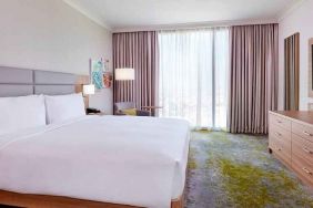 comfortable king room with TV and lots of natural light at Hilton Garden Inn Kuwait.