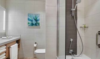 clean and spacious bathroom with shower and bath combo at Hilton Garden Inn Kuwait.