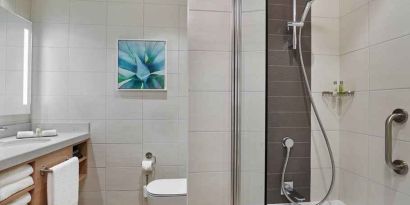 clean and spacious bathroom with shower and bath combo at Hilton Garden Inn Kuwait.