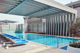 stunning outdoor pool with sunbeds at Hilton Garden Inn Kuwait.