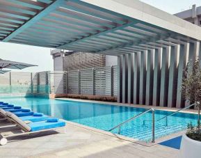 stunning outdoor pool with sunbeds at Hilton Garden Inn Kuwait.