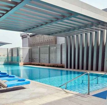 stunning outdoor pool with sunbeds at Hilton Garden Inn Kuwait.