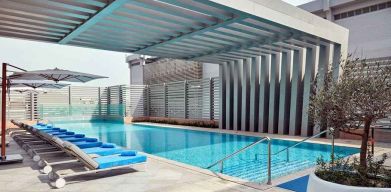 stunning outdoor pool with sunbeds at Hilton Garden Inn Kuwait.