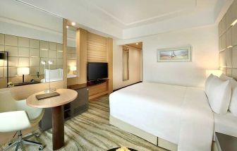 comfortable king room with TV, desk, and chair at DoubleTree by Hilton Riyadh - Al Muroj Business Gate.