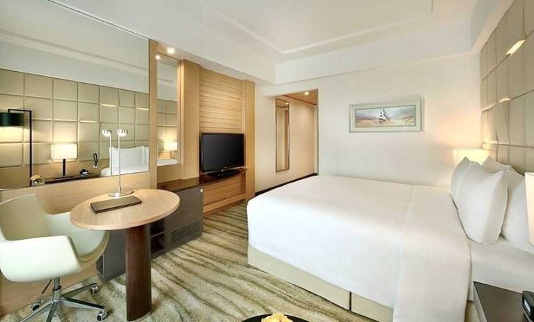 comfortable king room with TV, desk, and chair at DoubleTree by Hilton Riyadh - Al Muroj Business Gate.