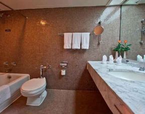 clean and spacious king bathroom with shower and bath combo at Hilton Addis Ababa.