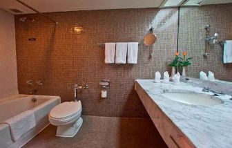 clean and spacious king bathroom with shower and bath combo at Hilton Addis Ababa.