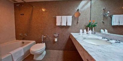 clean and spacious king bathroom with shower and bath combo at Hilton Addis Ababa.