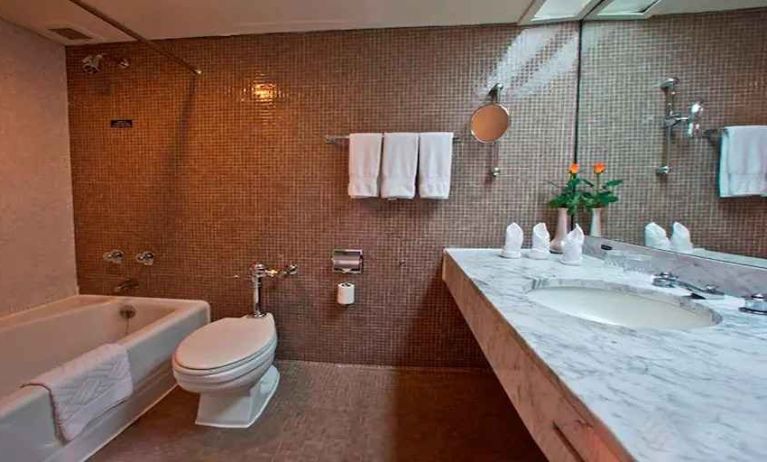 clean and spacious king bathroom with shower and bath combo at Hilton Addis Ababa.