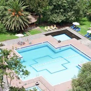 stunning outdoor pool with sun beds and umbrellas at Hilton Addis Ababa.