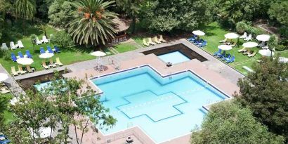 stunning outdoor pool with sun beds and umbrellas at Hilton Addis Ababa.