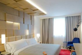 delux king room with TV, work desk, and chair at Canopy by Hilton Zagreb City Centre.