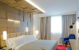 delux king room with TV, work desk, and chair at Canopy by Hilton Zagreb City Centre.