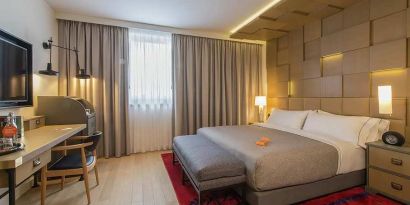 lovely king room with TV, work desk, and chair at Canopy by Hilton Zagreb City Centre.