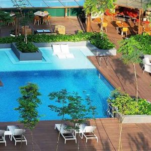 stunning outdoor pool surrounded by sun beds and seating area at DoubleTree by Hilton Hotel Johor Bahru.