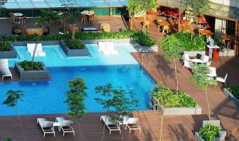 stunning outdoor pool surrounded by sun beds and seating area at DoubleTree by Hilton Hotel Johor Bahru.