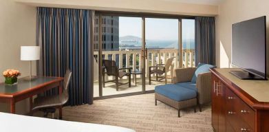 King bedroom with desk and balcony and at the Hyatt Regency San Francisco.