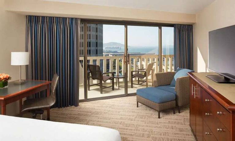 King bedroom with desk and balcony and at the Hyatt Regency San Francisco.