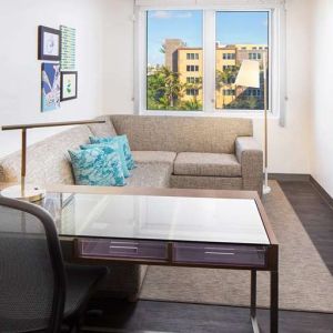 Living room with working station at the Element Miami International Airport.