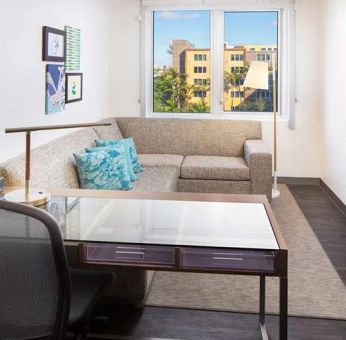 Living room with working station at the Element Miami International Airport.