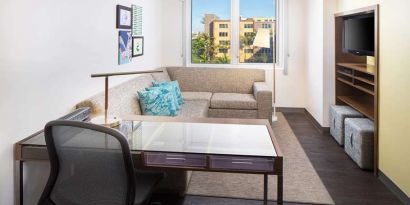 Living room with working station at the Element Miami International Airport.