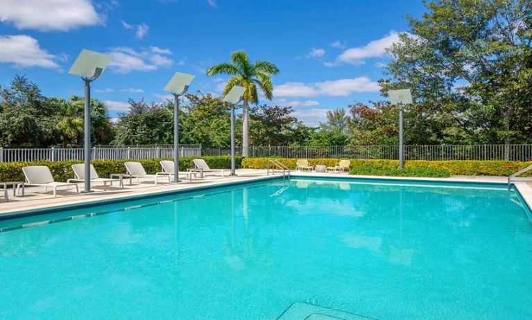 Outdoor pool with lounges at the Element Miami International Airport.