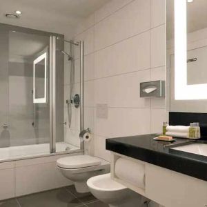 clean and spacious king bathroom with bath and shower combo at DoubleTree by Hilton Luxembourg.