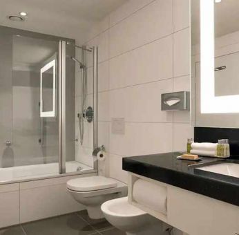 clean and spacious king bathroom with bath and shower combo at DoubleTree by Hilton Luxembourg.