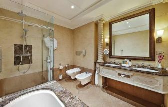 clean and spacious king bathroom with shower and bath at Hilton Beirut Habtoor Grand.