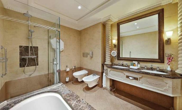 clean and spacious king bathroom with shower and bath at Hilton Beirut Habtoor Grand.