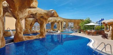 stunning outdoor pool surrounded by sun beds and seating area at Hilton Beirut Habtoor Grand.