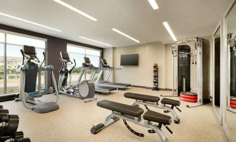 Fitness center with machines at Embassy Suites by Hilton Oahu Kapolei.