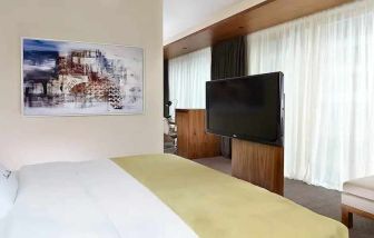 comfortable king room with TV at DoubleTree by Hilton Zagreb.