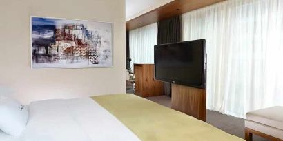 comfortable king room with TV at DoubleTree by Hilton Zagreb.