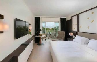 comfortable king room with TV and outdoor terrace at Hilton Nicosia.